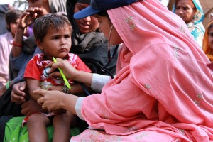 A female doctor with the International Medical Corps examines a