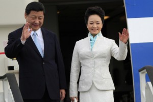 Chinese President Xi Jinping and First Lady Peng Liyuan wave from their plane upon their arrival at Julius Nyerere International Airport in Dar es Salaam