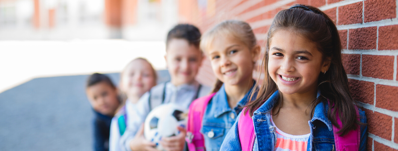 students outside school standing together