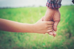 father holding daughter hand