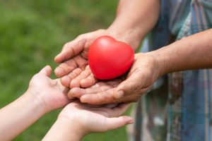 adult with child holding a heart