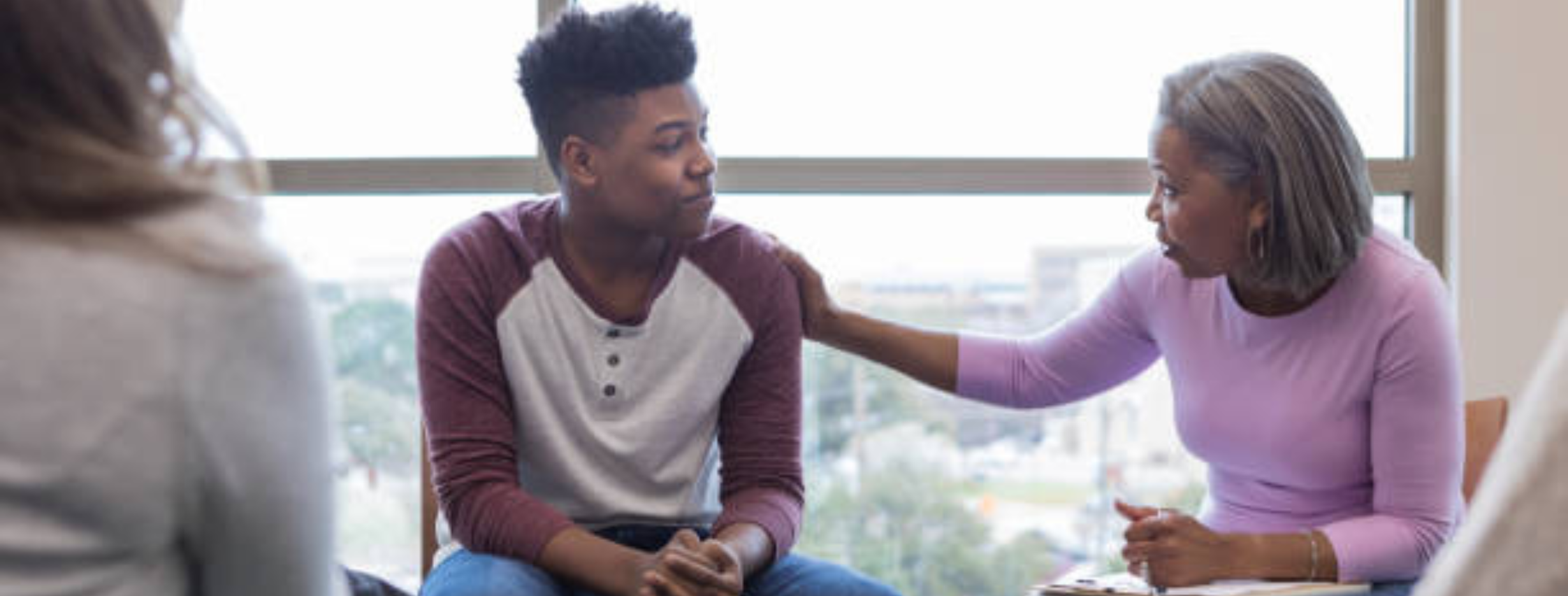 Black teen getting support from adult
